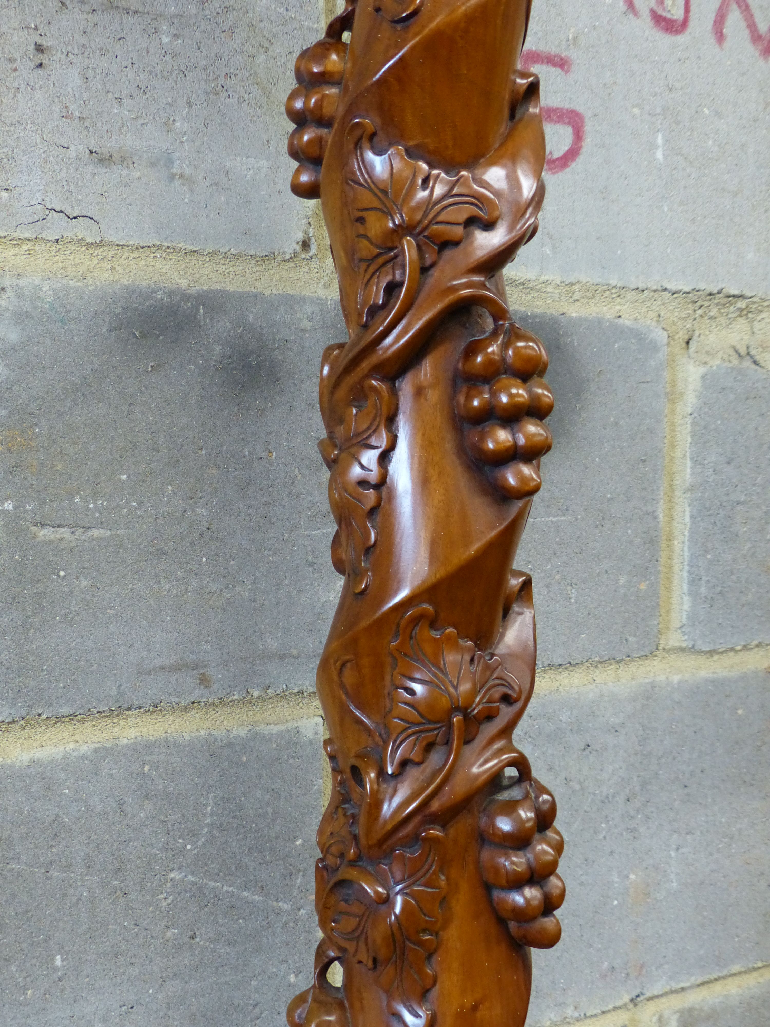 A reproduction carved mahogany torchere, height 114cm